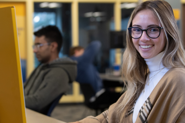 Student sits at computer in the library